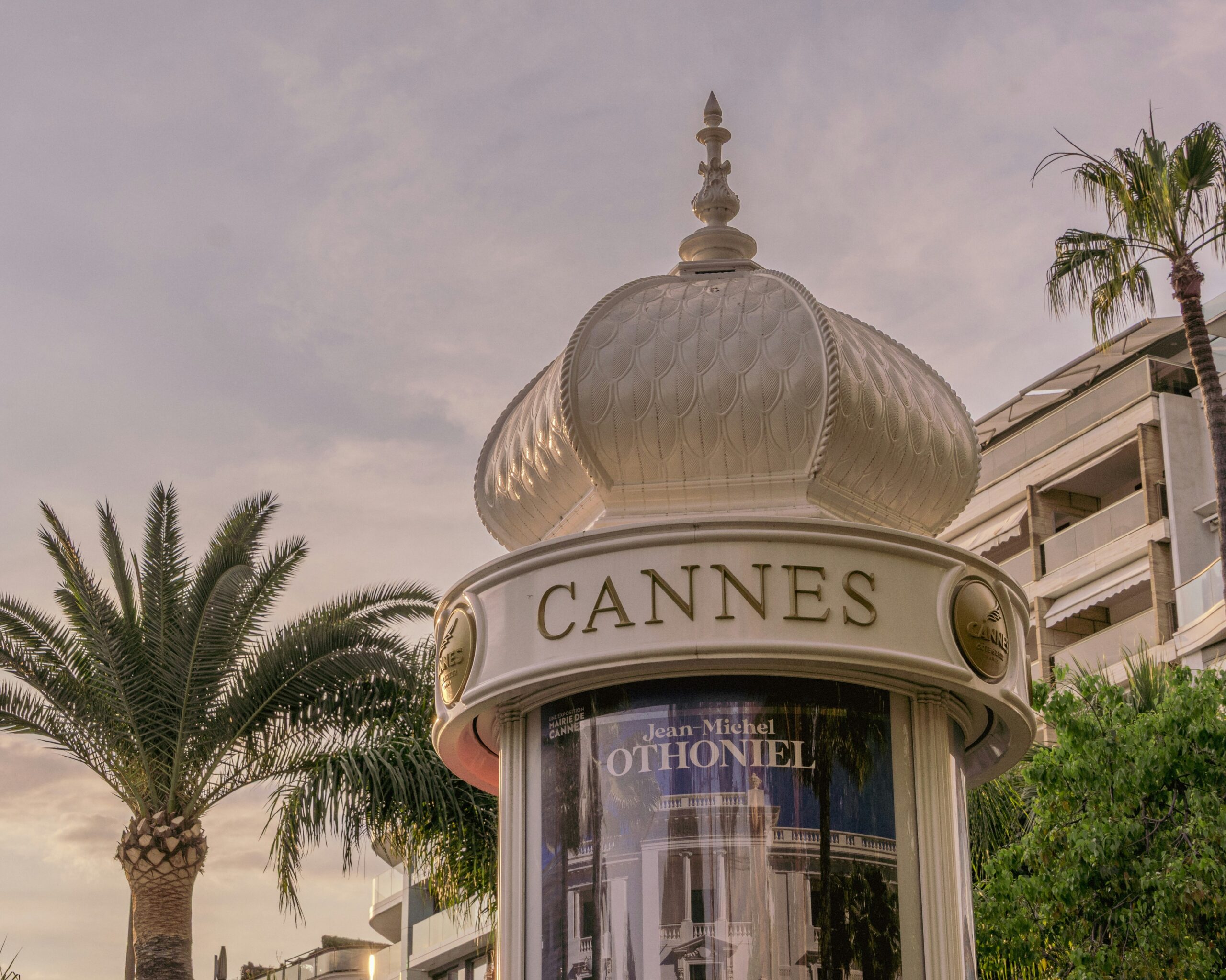 Vue nocturne de la Croisette à Cannes avec le front de mer illuminé et des passants en tenue de soirée se rendant à un spectacle de danse